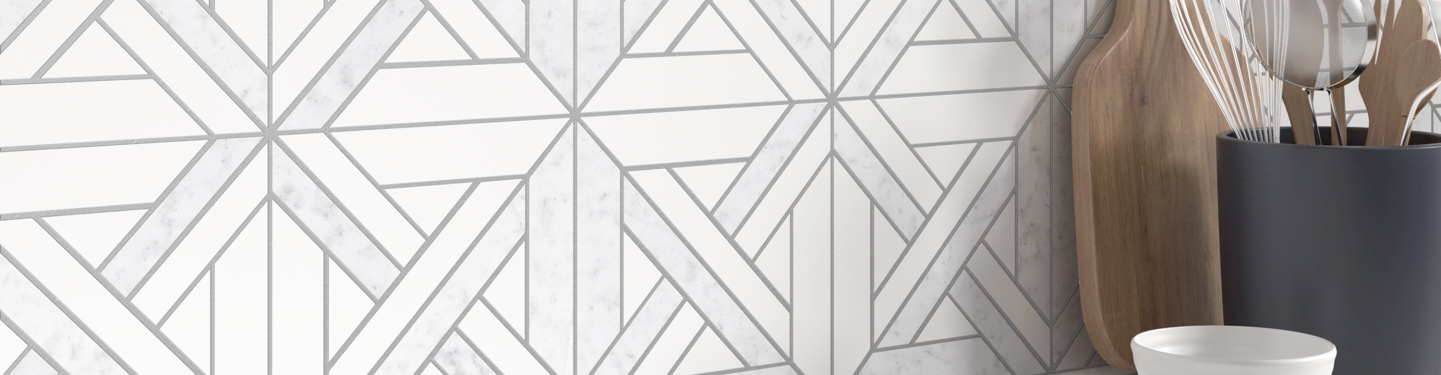 Geometrical white and greyscale patterned tile backsplash 